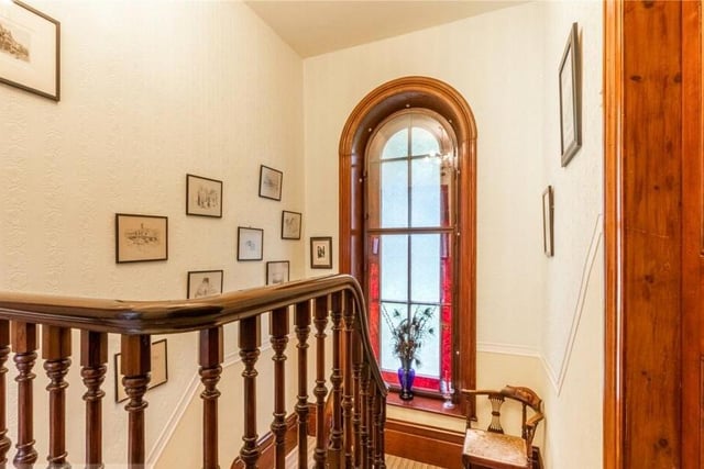 A stunning feature window lights the stairway.
