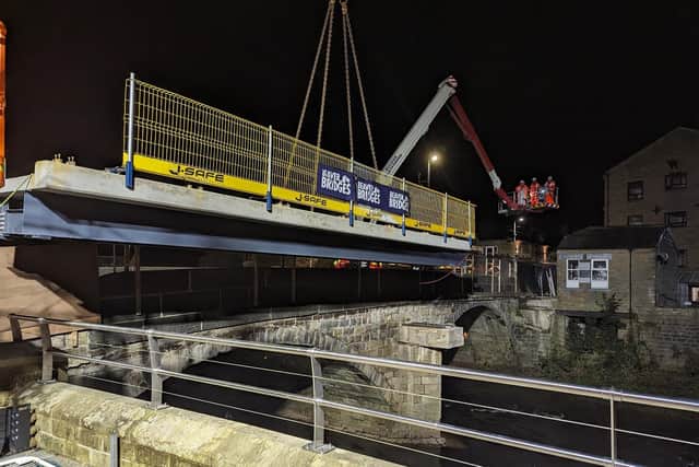 The new bridge is made of concrete, glass and stainless steel. It has been designed carefully with due consideration given to the listed status of the adjacent historic road bridge.
