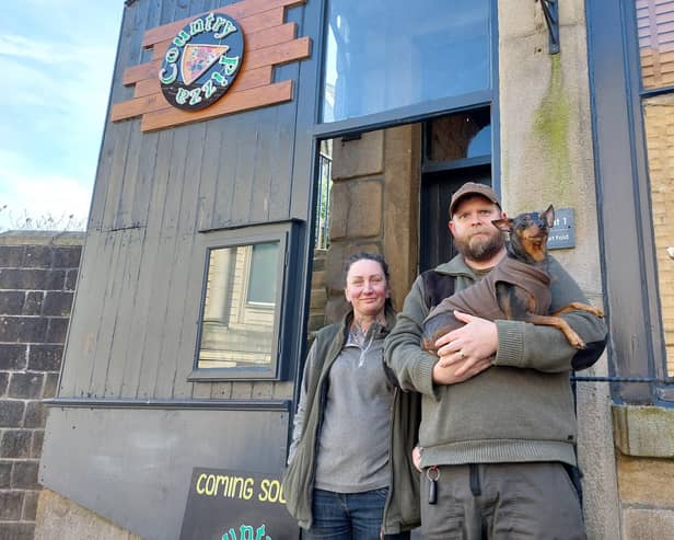 Joanna, Rik and their mini pinscher Clyde outside Country Pizza