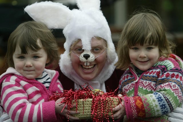 In 2005, three-year-old twins Lilly and Grace Best with Easter Bunny, Leanne Clegg, make and roll decorated Easter eggs at Eureka, Halifax.