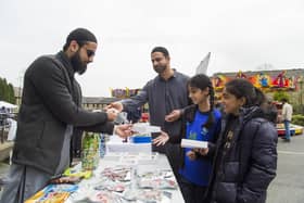 Last year's Eid Festival at Jamia Masjid Madni Mosque, Halifax. From the left, Zain Ali sell some sweets to Mohammed Nisar, Ilyana Najib, eight, and Zahra Hussain, eight.