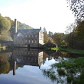 Gibson Mill reflected in the water. Photo by Mike Halliwell