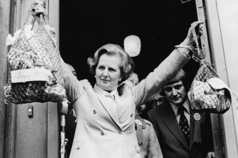 Conservative Party leader Margaret Thatcher holding up two different sized shopping bags, illustrating the difference between the drop in the value of the one pound note under the Labour government, during canvassing for the General Election in Halifax, April 25th 1979.