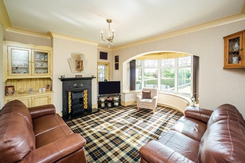 The lounge, with feature fireplace and wide bay window.