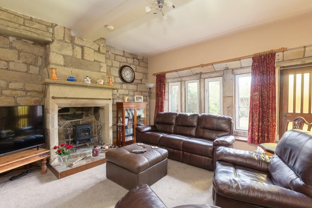 The sitting room features exposed stonework, stone fireplace and beautiful beam ceiling.