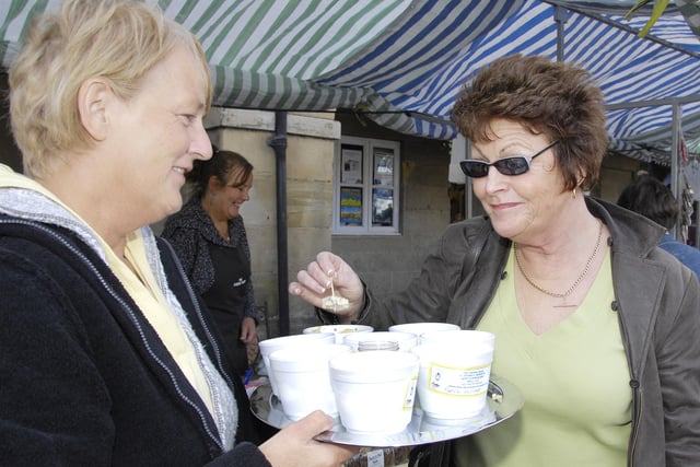 A festival visitor tries a free sample.