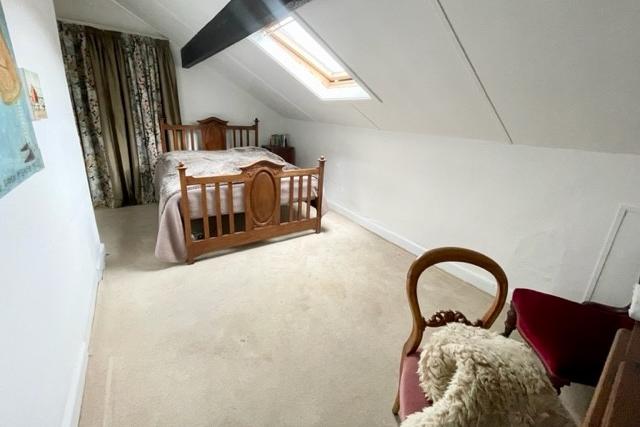 Beamed bedroom space within the property.