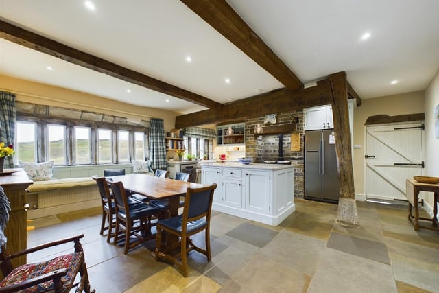 The kitchen room boasts Indian-stone flagged flooring and exposed beams