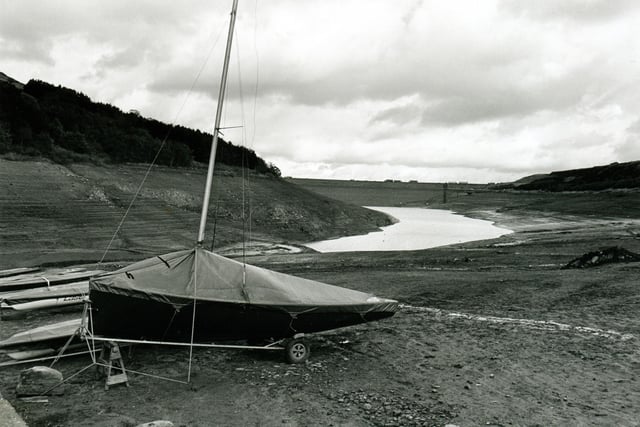 A small sailing dinghy left high and dry at Scammonden Dam during a drought in 1995