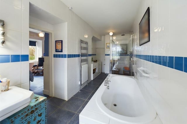 A family bathroom with both bath and shower.