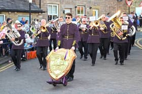 Principal cornet Tom Smith, with the British Open Shield, leads B&R as they march at Lees and Springhead in the Whit Friday contest earlier this month