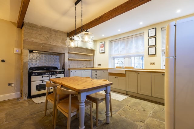 An alternative view of the kitchen space, showing the cooker set in to the chimney breast.