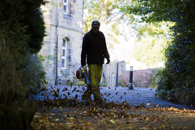 Robert Balmforth from Calderdale Council Safer Cleaner Greener clears the fallen leaves at Manor Heath Park in Halifax.