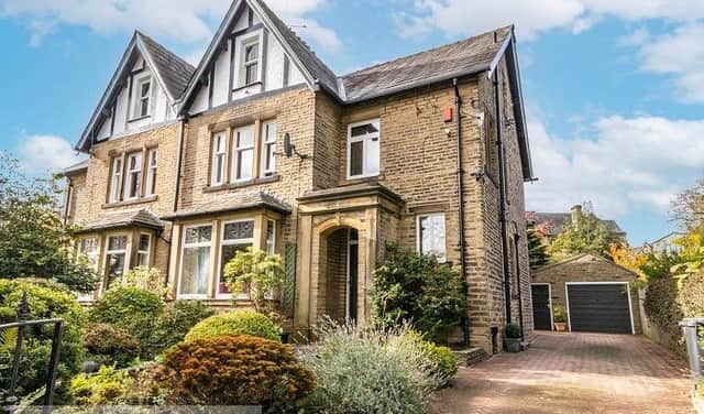 The semi-detached home has an attractive frontage with a stone porch and leafy garden.
