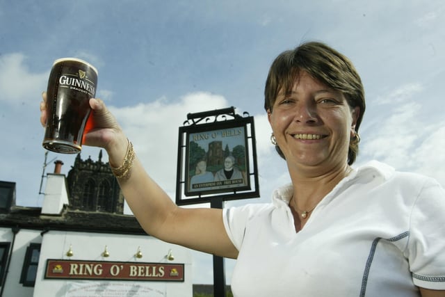 Landlady at the Ring of Bells Angie Hodgkins raises a pint back in 2003.