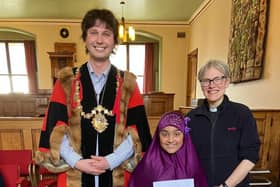 Todmorden mayor, Tyler Hanley (left) and the Rev Catherine Shelley (right) with nine-year-old Habeebah Malik at Todmorden Town Hall