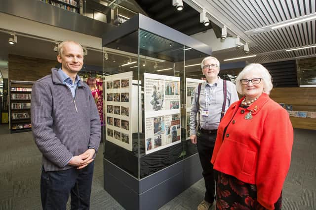 Exhibition of photos from The Queen's visit to Halifax in 2004 at Halifax Central Library. From the left, photographer Mark Russell, library customer services coordinator Craig Oliver and former mayor Geraldine Carter.