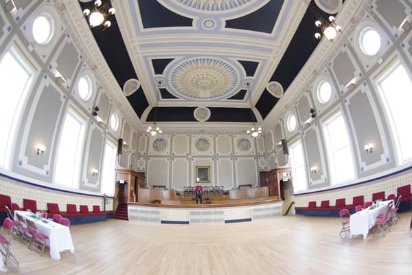 The main hall, where a new bar has been created using materials repurposed from the court room.