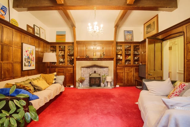 An original stone fireplace and 'Dickensian style' panelled walls in the sizeable lounge.