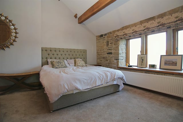 A beamed and spacious double bedroom within the farmhouse.