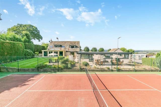 A luxurious home with gardens, stables, tennis courts and indoor leisure suite.