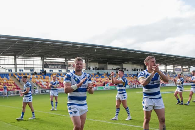 Halifax Panthers players applaud their fans following their Summer Bash defeat to Batley Bulldogs at the LNER Community Stadium, York, UK. Photo by Simon Hall.