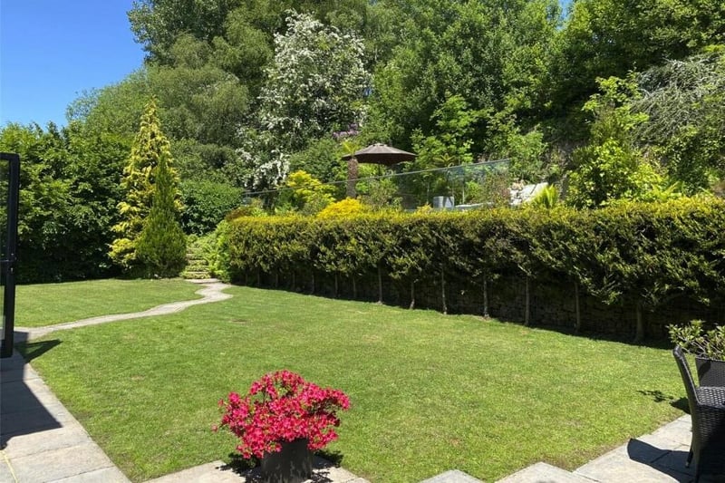Glorious gardens with lawns, trees and shrubs, and strategic seating areas form part of the property.
