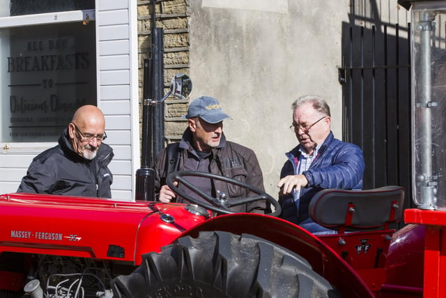 From the left, Peter Shickell, David Batty and Jim Norcliffe loo at a Massey Ferguson tractor.