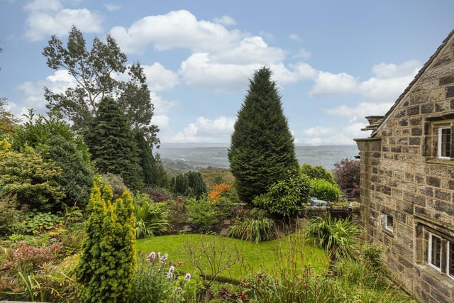 The enclosed side garden with deep borders and a stunning vista.