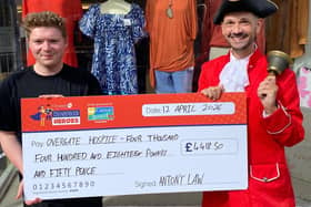 Todmorden's Town Crier Antony Law hands over a cheque for more than four thousand pounds to Overgate Hospice.