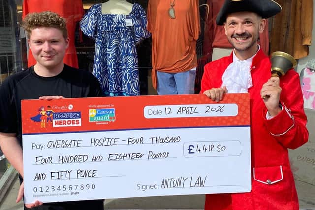 Todmorden's Town Crier Antony Law hands over a cheque for more than four thousand pounds to Overgate Hospice.