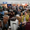 Passengers wait at Stansted Airport after UK flights were delayed over a technical issue (Getty Images)