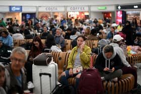 Passengers wait at Stansted Airport after UK flights were delayed over a technical issue (Getty Images)