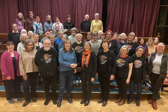 Members of the Three Valleys Gospel Choir with Todmorden Food Drop In volunteer and choir member Maggie Griffiths.