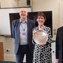Linda Smith being presented with the Christine Stewart Customer Service Award in recognition of her 50 years of service to Calderdale Council's library service, with David Duffy - libraries manager - and Tom Stewart.