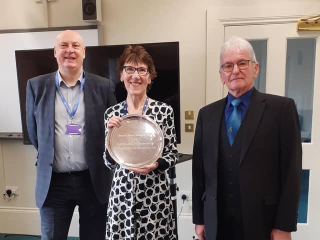 Linda Smith being presented with the Christine Stewart Customer Service Award in recognition of her 50 years of service to Calderdale Council's library service, with David Duffy - libraries manager - and Tom Stewart.
