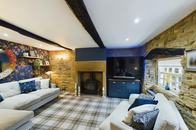The cosy beamed lounge, with stone fireplace and warming log burner.