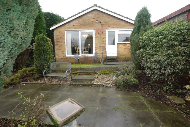 View of the bungalow for sale, its accommodation comprising a kitchen, lounge and diner, two bedrooms, a bathroom, and outside there is driveway parking with gardens and a garage.
For sale with Daniel and Hirst, Brighouse, tel. 01484 711200.