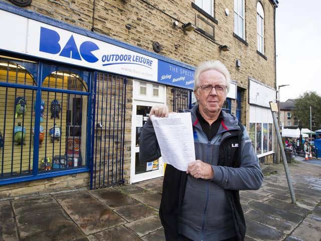 Dave Jackson at BAC Outdoor Leisure, Elland, with petition of traders who want to save Coronation Street Car Park.