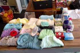 Knitted items for the Baby Bank in Heckmondwike which supplies disadvantaged families with pre-loved baby equipment such as cots, prams, clothing and baby food.