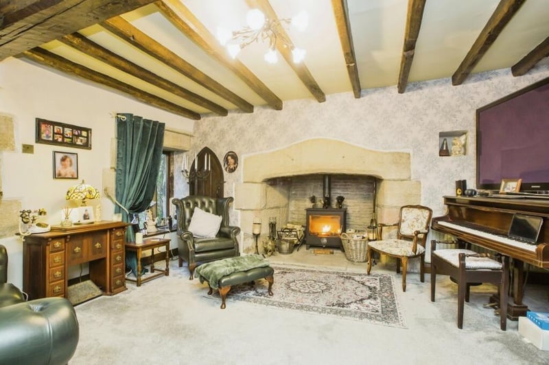 The beamed lounge has a large stone fireplace with woodburner stove.
