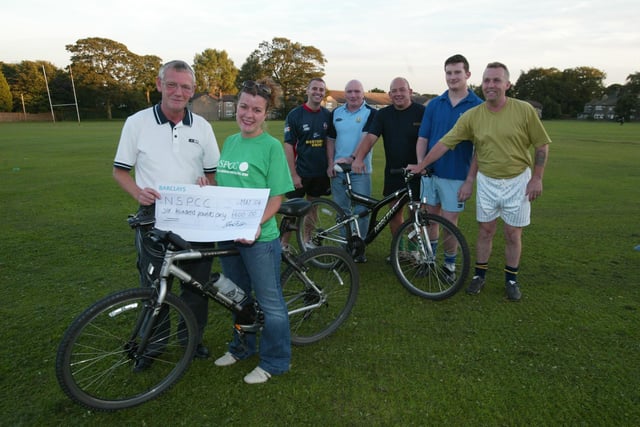 NSPCC sponsored bike ride at Illingworth Sports and Social Club in 2004. Chairman Stephen Anderson and NSPCC Community Appeals Manager Helen Verity.