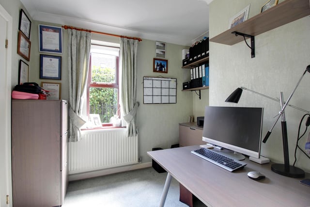 Office or work from home space, with a window and shelving.