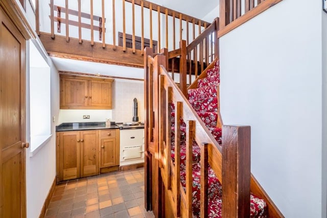 A glimpse of the kitchen and the staircase leading up to two further floors with mezzanine levels.