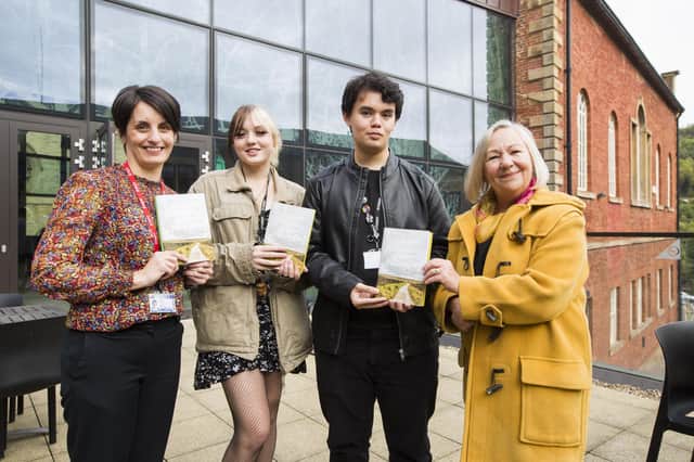 Young arts coordinator Jo Harris from The Arts Society Halifax, right, presents poetry competition prizes to head of English Ruth James, left, and students Billie-Jo Wood and James Lagutin, from Brighouse High School.
