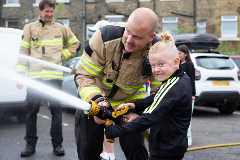 Firefighter James Barker with Albie Brown at Halifax Fire Station open day
