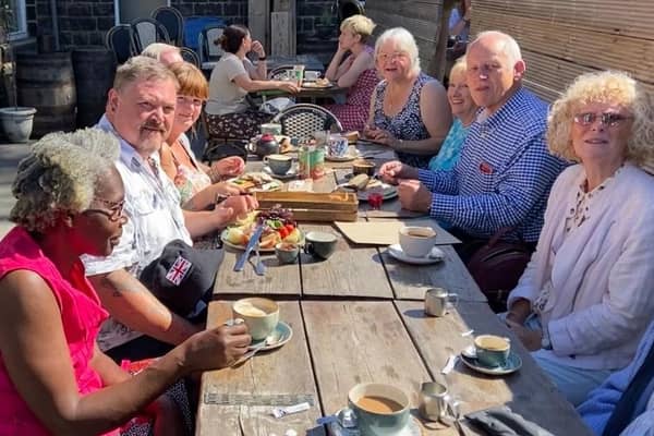 Members of Brighouse and Huddersfield enjoying a sunny lunch in Uppermill recently