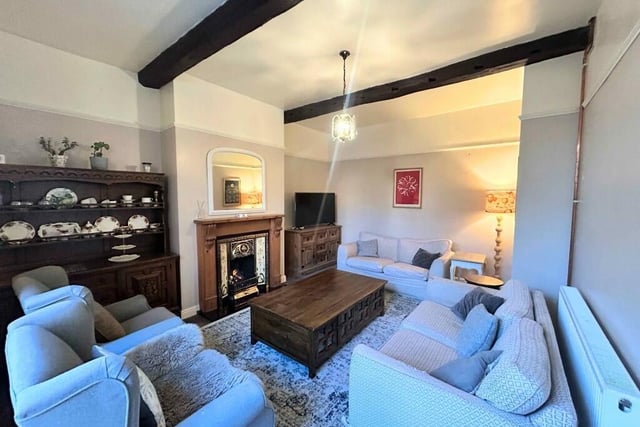 A cosy sitting room with feature fireplace.