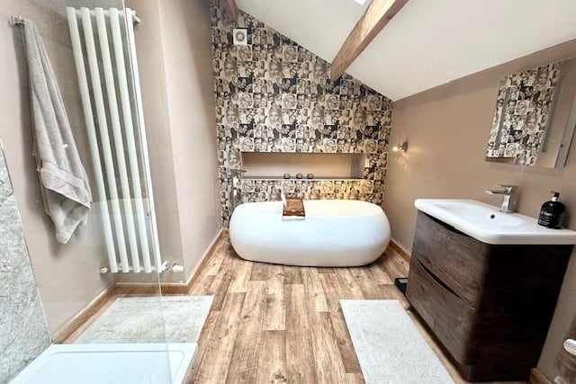 A luxury en suite with egg-shaped bath, and a walk-in shower.