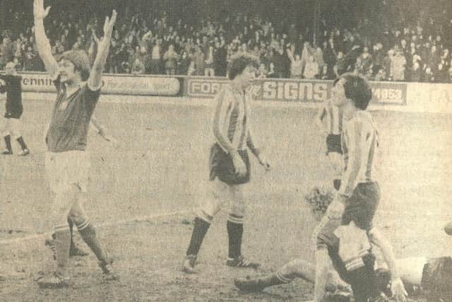 Smith raises his arms aloft after scoring in the 1-1 draw with Brentford at The Shay, 25 February 1978.